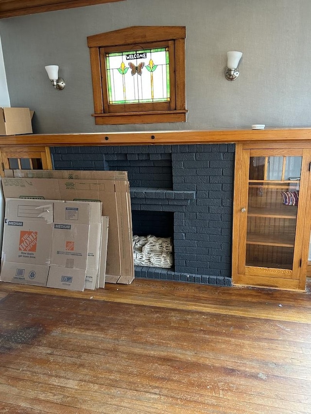 room details with hardwood / wood-style flooring and a brick fireplace