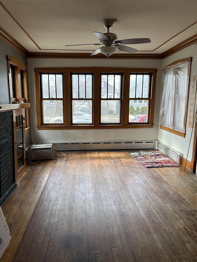 unfurnished living room with dark hardwood / wood-style floors, a healthy amount of sunlight, ceiling fan, and a brick fireplace