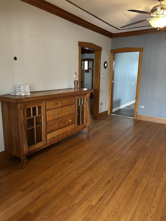 spare room with hardwood / wood-style flooring, ceiling fan, and ornamental molding