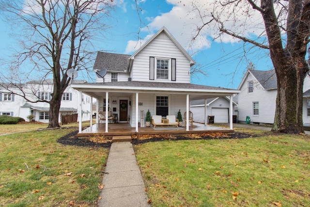 country-style home with a porch, a garage, and a front lawn