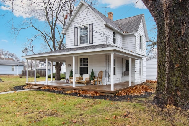 farmhouse-style home with a porch and a front lawn