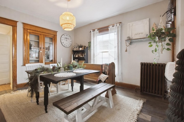 dining room with radiator and dark hardwood / wood-style flooring