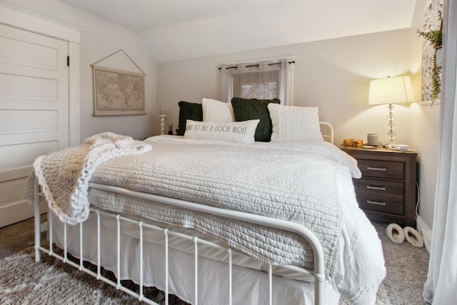 carpeted bedroom featuring lofted ceiling