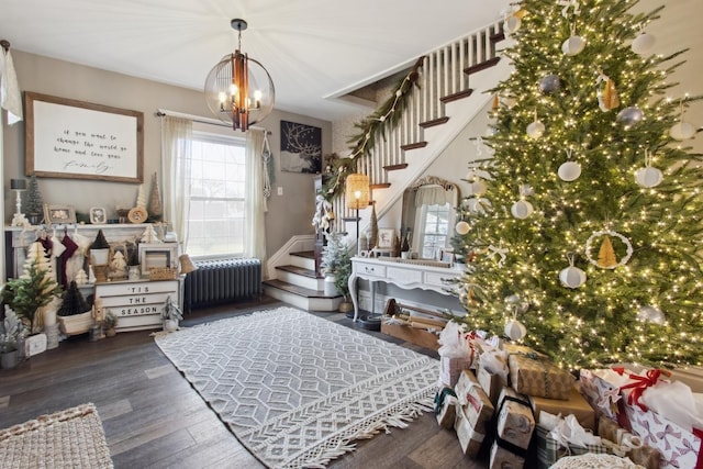 interior space featuring radiator heating unit, a chandelier, and hardwood / wood-style flooring