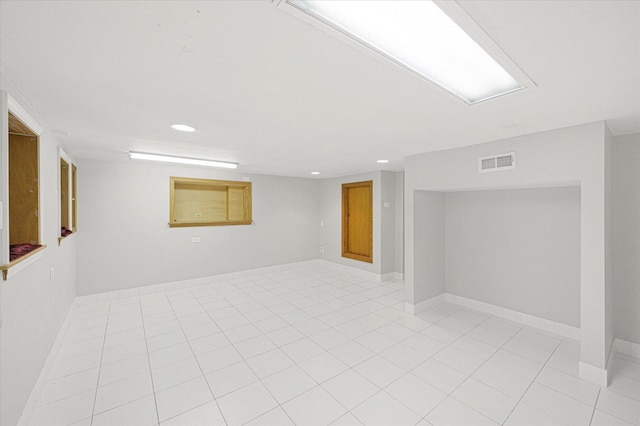 basement with light tile patterned flooring