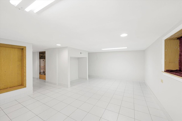 interior space with light tile patterned floors and gas water heater