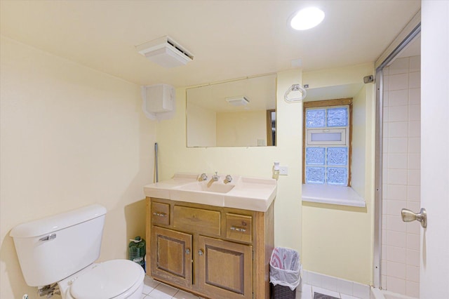 bathroom featuring toilet, vanity, and tile patterned floors