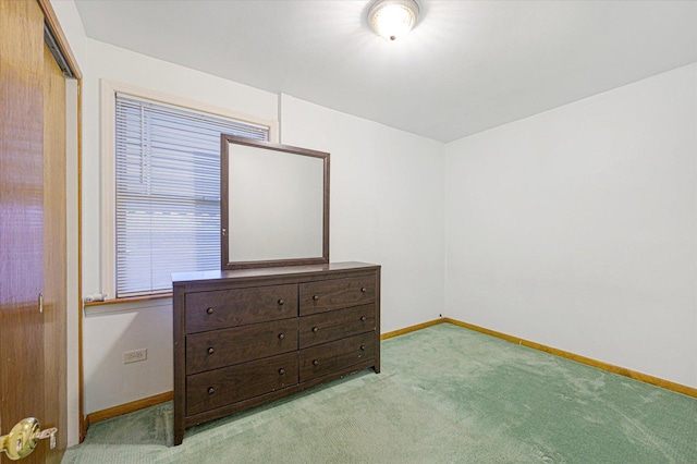 unfurnished bedroom featuring light carpet and a closet