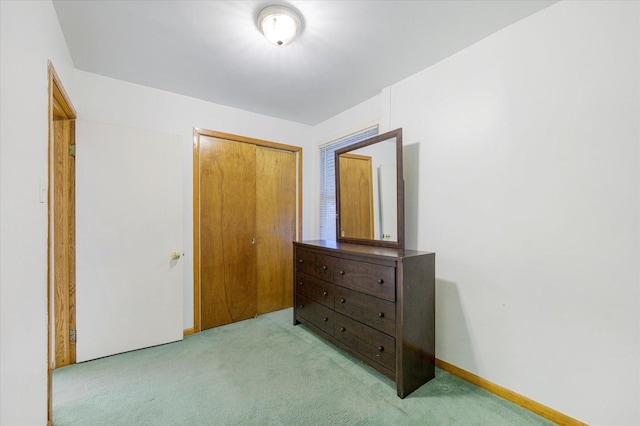 bedroom with light carpet and a closet