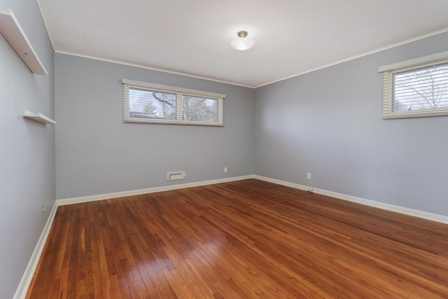 unfurnished room with dark wood-type flooring and crown molding