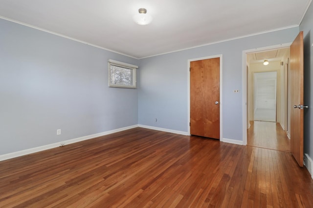 spare room with dark wood-type flooring and ornamental molding