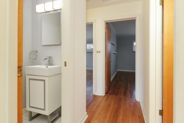 hallway with sink and hardwood / wood-style floors