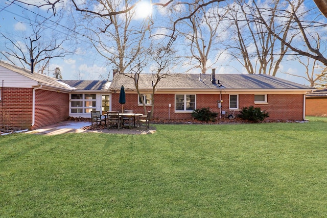 back of property with a yard and a patio area