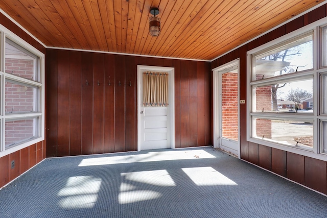 unfurnished sunroom with wooden ceiling