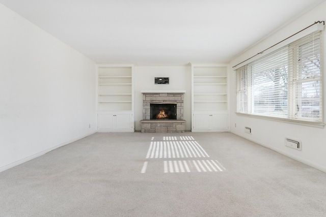 unfurnished living room featuring light colored carpet and a fireplace