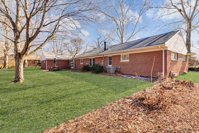 back of house featuring central AC unit and a lawn