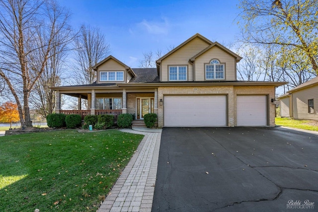 front of property featuring covered porch, a front yard, and a garage