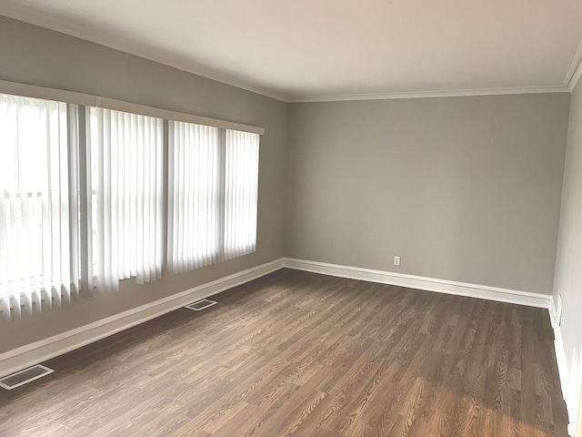 unfurnished room featuring crown molding, a healthy amount of sunlight, and dark hardwood / wood-style floors