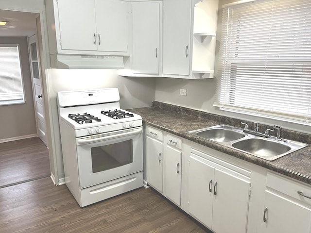 kitchen with white gas range, sink, dark hardwood / wood-style floors, range hood, and white cabinets