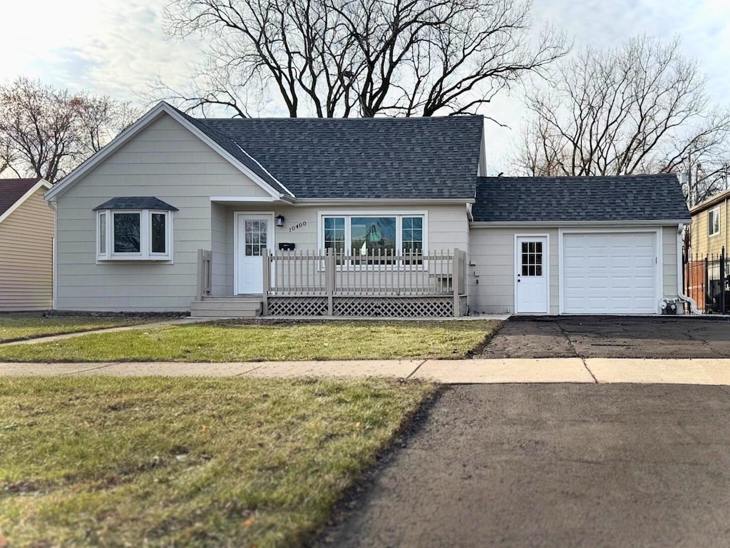 ranch-style house with a front yard and a garage