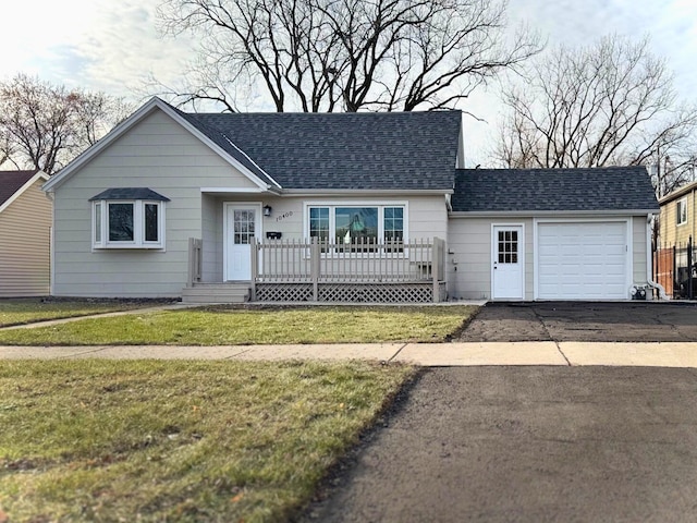 ranch-style house with a front yard and a garage