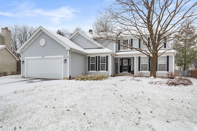 traditional-style home with a garage and fence