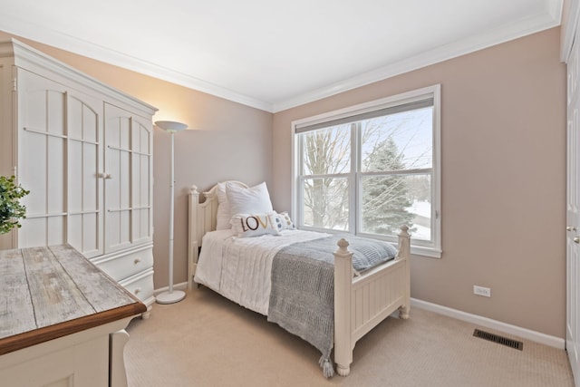 bedroom featuring baseboards, visible vents, crown molding, and light colored carpet