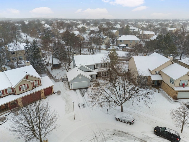 snowy aerial view featuring a residential view