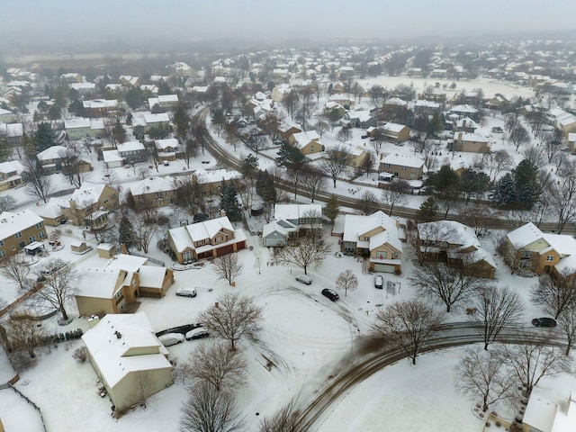 snowy aerial view with a residential view