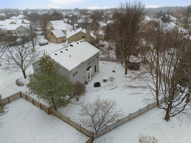 snowy aerial view with a residential view