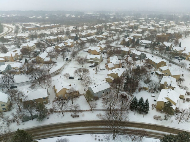 snowy aerial view featuring a residential view