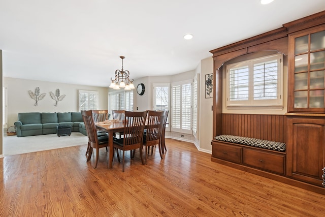 dining space featuring light wood-style floors, recessed lighting, baseboards, and an inviting chandelier