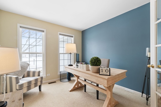 office space with carpet, visible vents, and baseboards