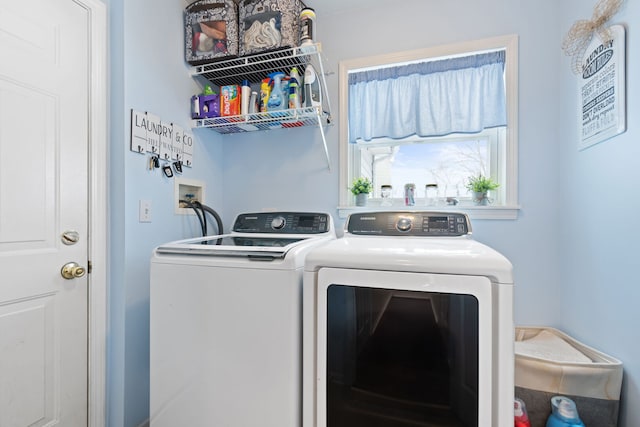 clothes washing area featuring washer and dryer and laundry area