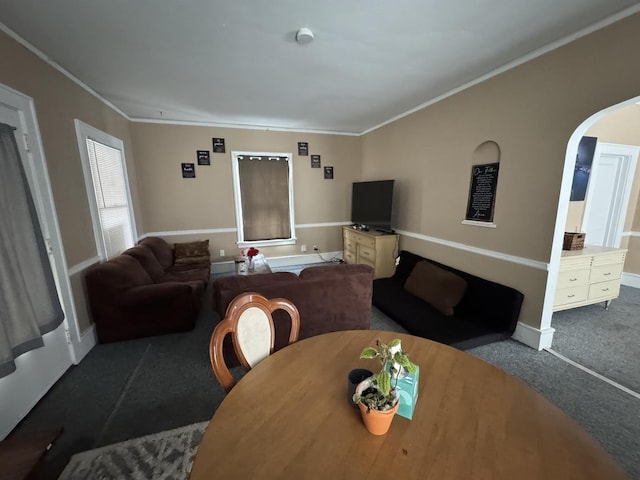 carpeted dining room featuring ornamental molding