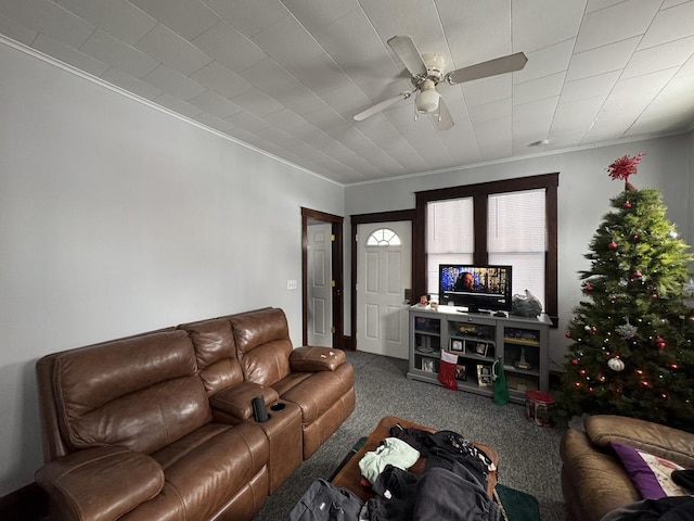 carpeted living room with ceiling fan and crown molding