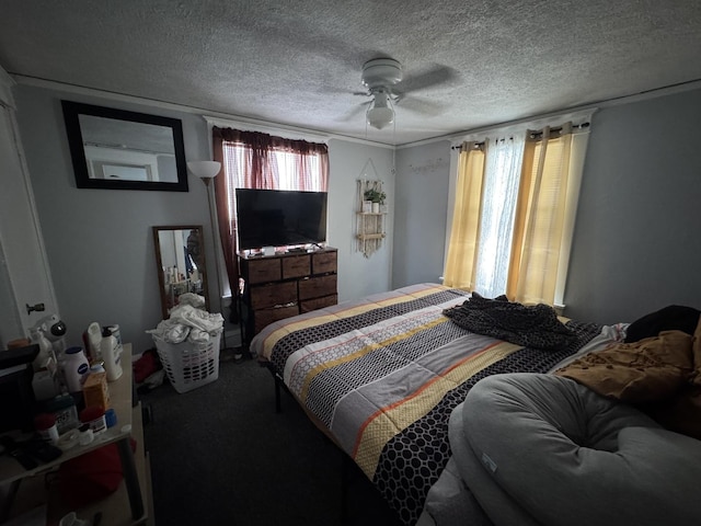 bedroom with ceiling fan and a textured ceiling