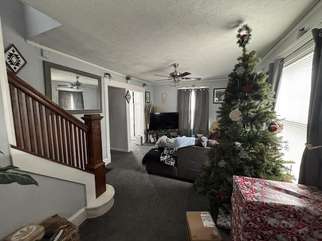 living room with carpet flooring, ceiling fan, and a textured ceiling