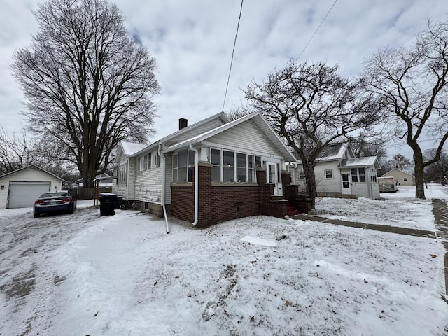 view of front of house featuring a garage and an outdoor structure