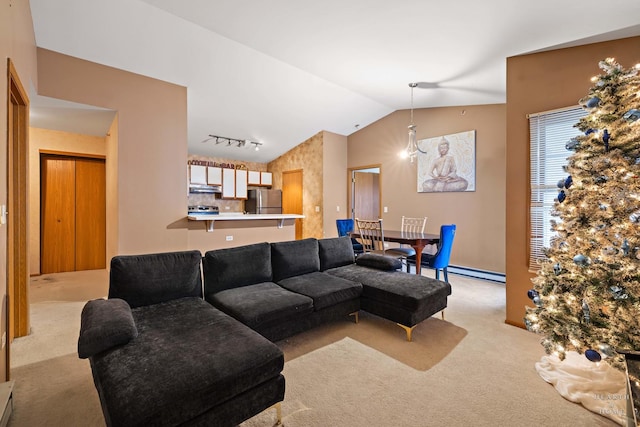 carpeted living room with baseboard heating, lofted ceiling, and track lighting