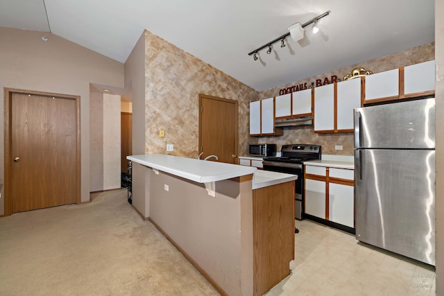 kitchen featuring lofted ceiling, light colored carpet, stainless steel appliances, white cabinets, and rail lighting