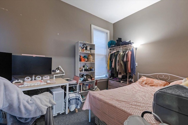 carpeted bedroom featuring a closet and vaulted ceiling