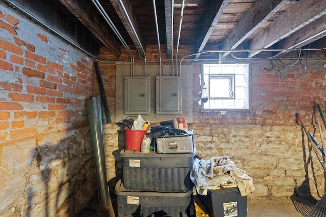 basement with brick wall and electric panel