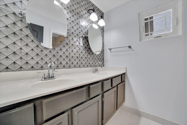 bathroom with vanity, tasteful backsplash, and tile patterned floors