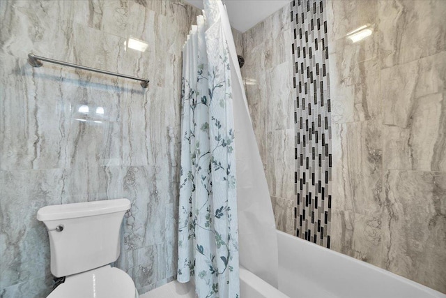 bathroom featuring toilet, tile walls, and shower / tub combo with curtain