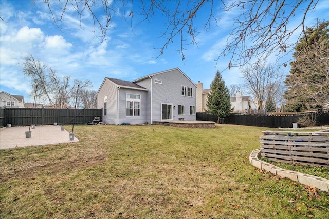 back of property featuring a patio area and a lawn