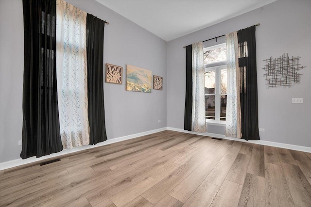 unfurnished room with light hardwood / wood-style floors