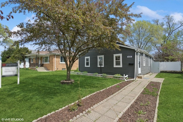 view of front of property with fence and a front lawn