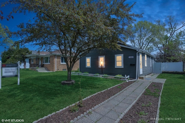 view of front of house with a front yard and fence