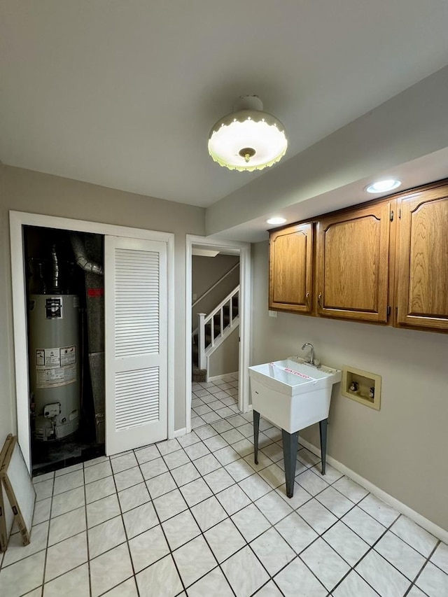 washroom featuring cabinets, washer hookup, and gas water heater